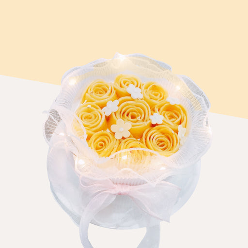 Chiffon cake topped with mango roses with LED lights, decorated to look like a bouquet of flowers