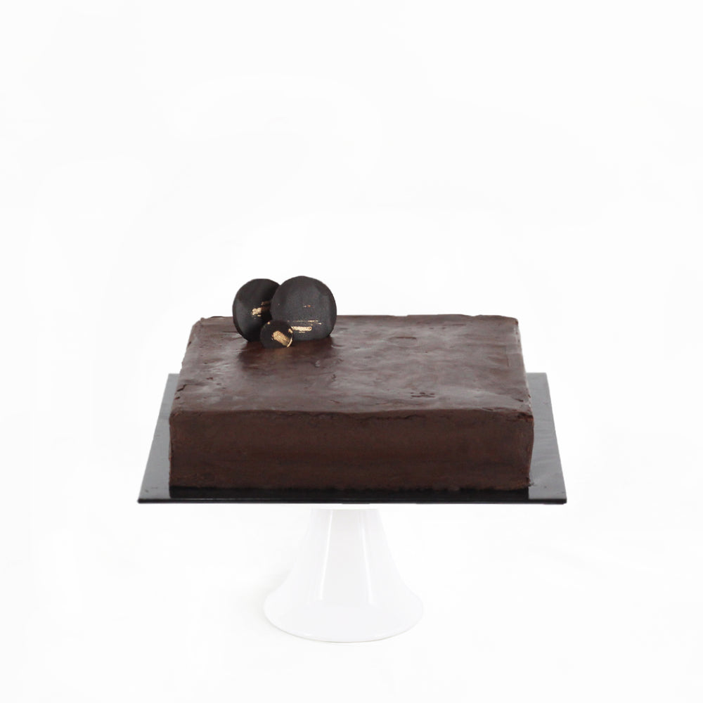 Chocolate cake with peach puree and dark chocolate ganache