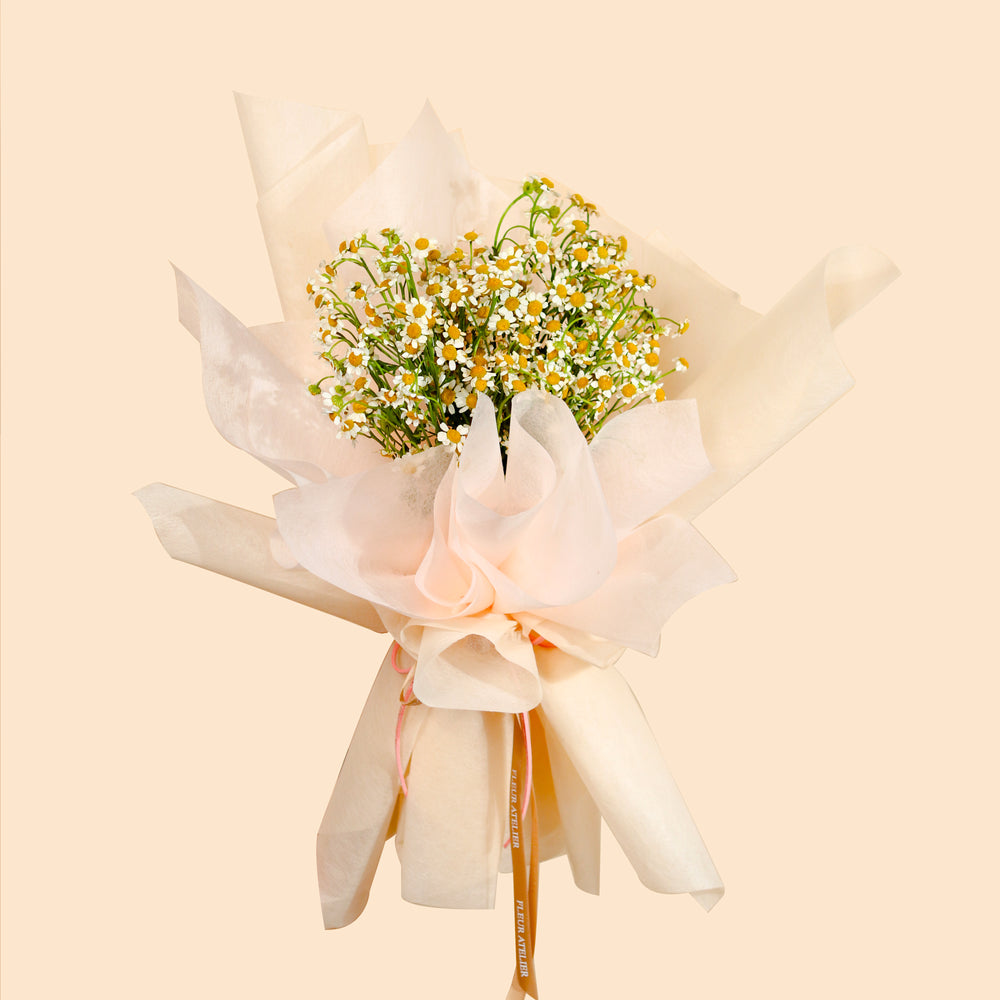 Chamomile bouquet wrapped in pink beige wrapper