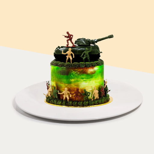 Cake decorated with toy soldier figurines and a toy tank