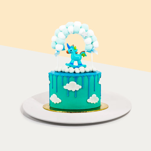 Gender reveal baby boy cake with unicorn figurine
