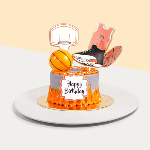 Butter cake frosted with orange and grey buttercream, decorated with basketball elements