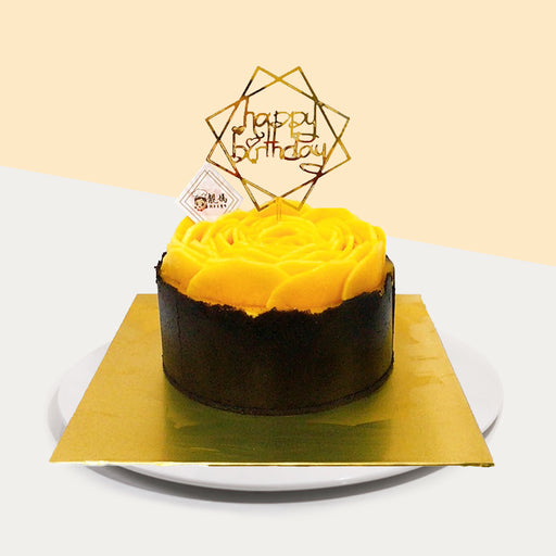 Mango mousse cake with an Oreo base, with fresh mango within and on top of the cake