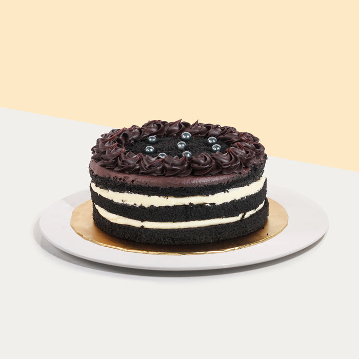 Black chocolate cake with layers of rich vanilla cream cheese