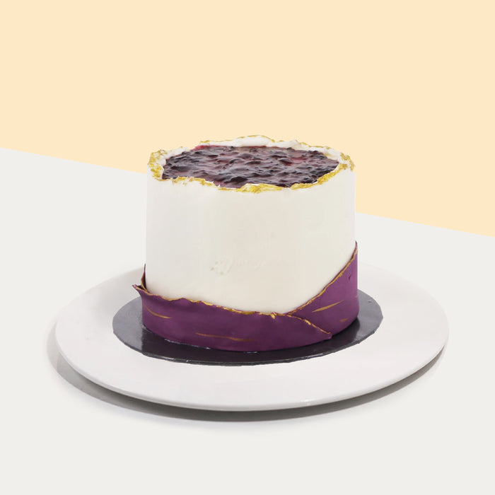 Vanilla butter cake with blueberry filling, decorated with thin layers of fondant