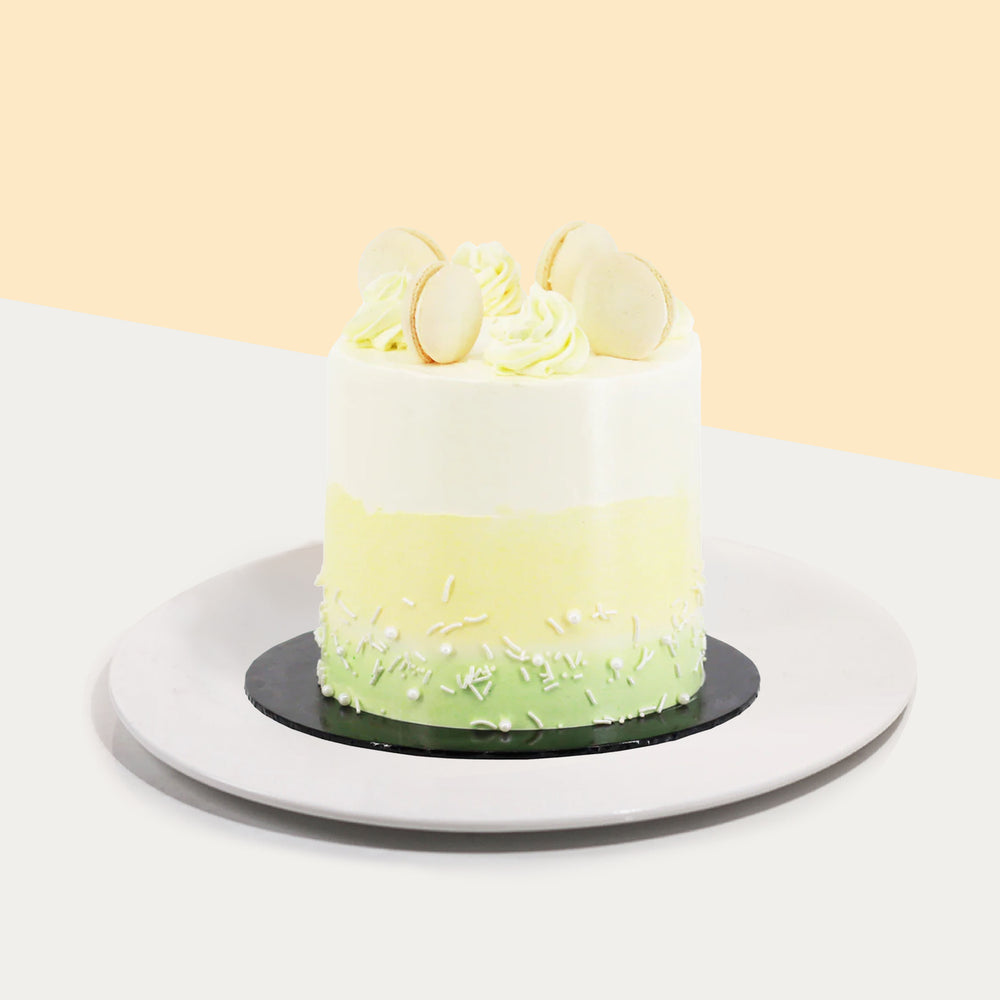 Buttercream cake frosted with green, yellow and white buttercream