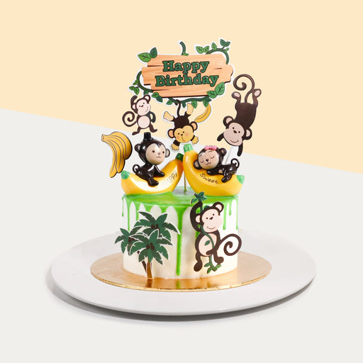 Butter cake frosted with buttercream, topped with monkey design elements