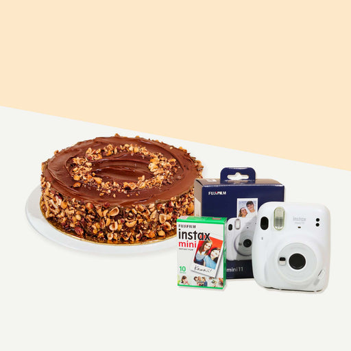 Cake coated with hazelnut spread, garnished with hazelnuts on the top and sides with an Instax Camera