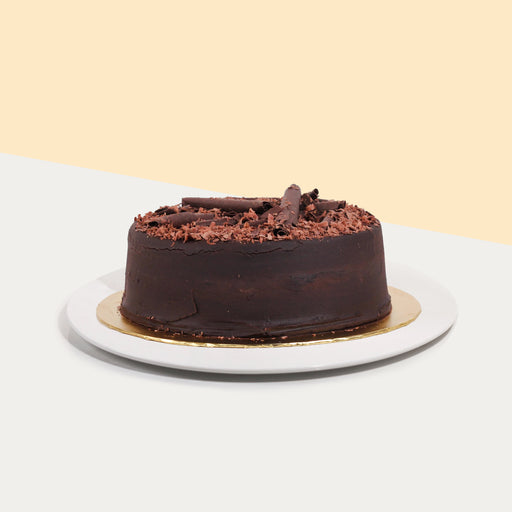 Dark chocolate cake with creamy chocolate ganache topped with chocolate shavings