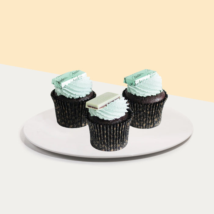 Chocolate cupcakes filled with mint chocolate ganache, frosted with mint buttercream and topped with Andes mint candy
