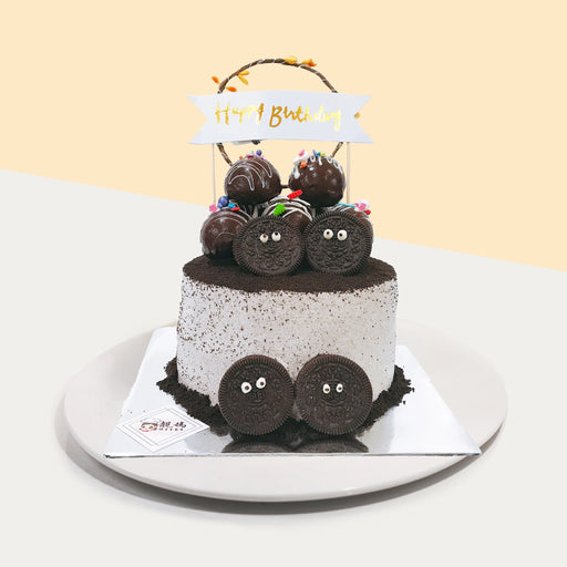 Callebaut chocolate chiffon cake, frosted with cookies and cream, topped with Oreo pieces