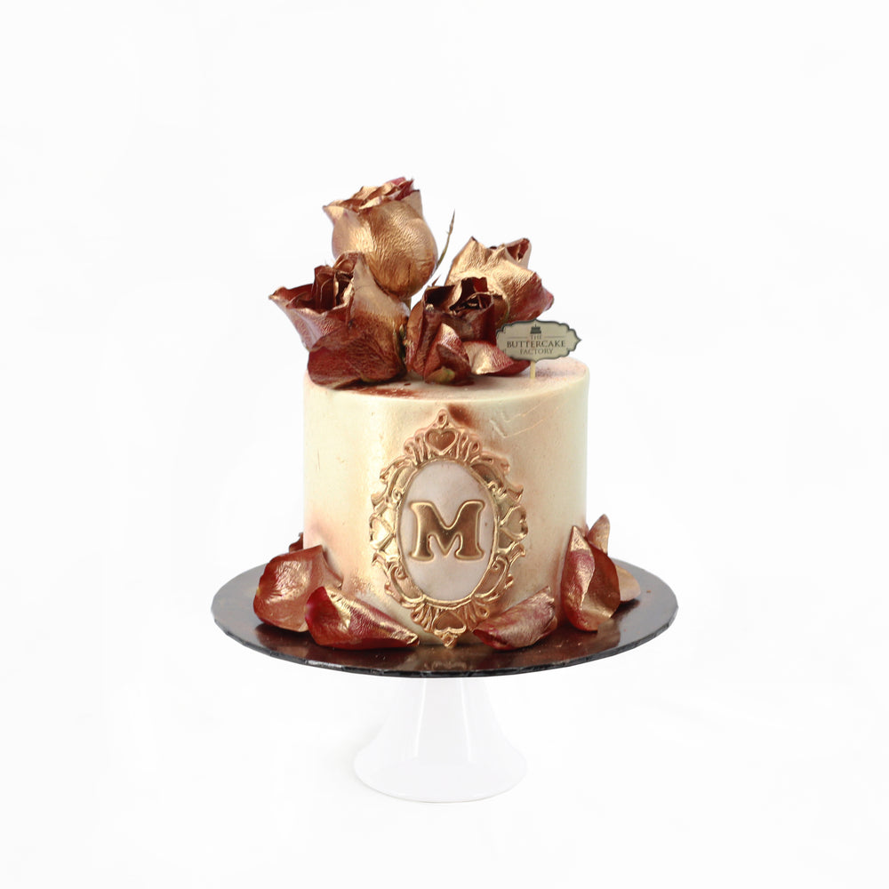 Butter cake with golden painted flowers, and an initial of your choosing