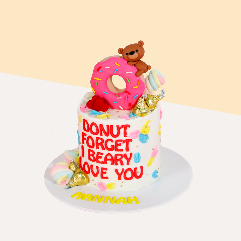 Cake with written pun, topped with a fondant donut and bear figurine