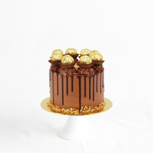 Chocolate cake with chocolate hazelnut buttercream, dripped with chocolate ganache, and topped with peanuts