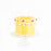 Yellow cake decorated with cream swirls, topped with sugar pearls