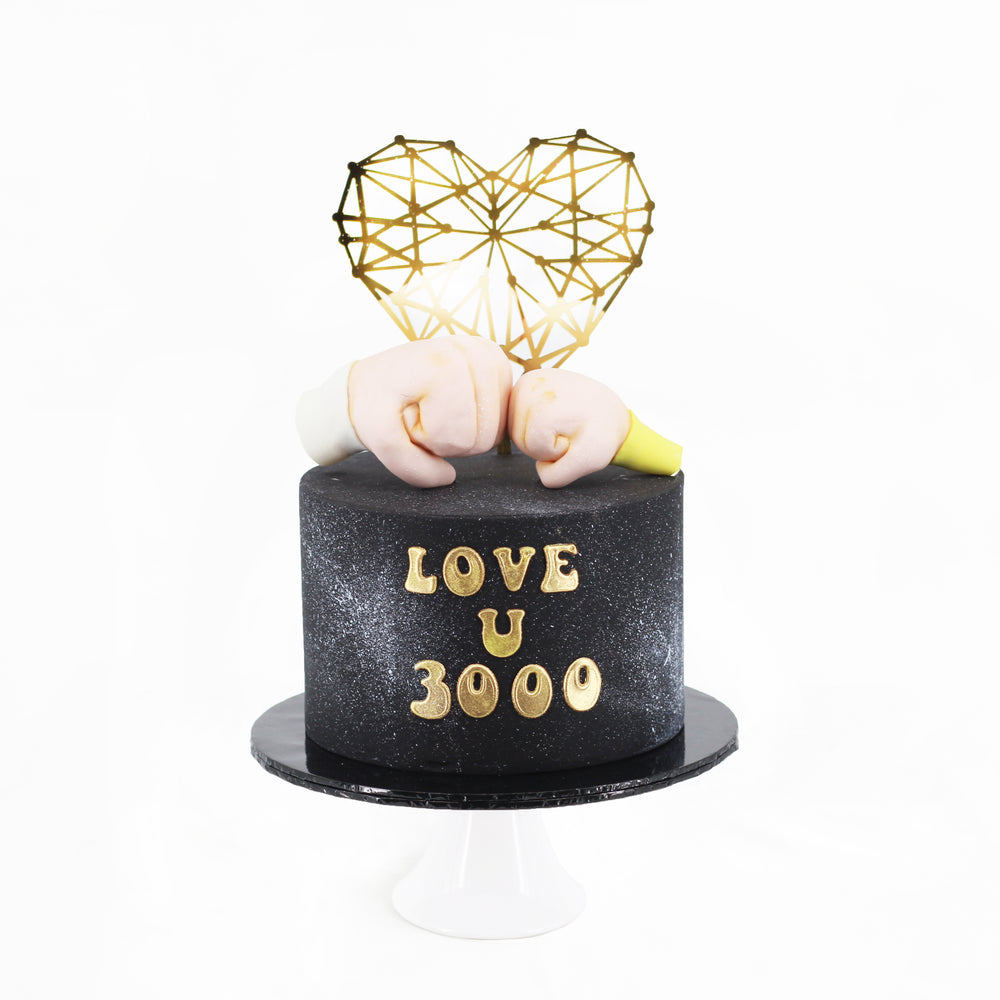 Black buttercream cake with Love U 3000 wordings, and gold heart-shaped topper