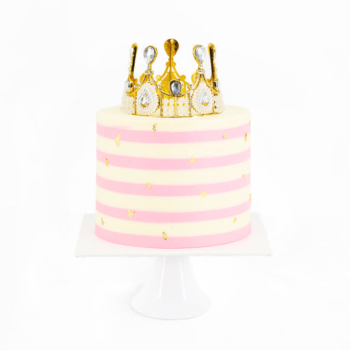 Pink and white buttercream cake with golden crown