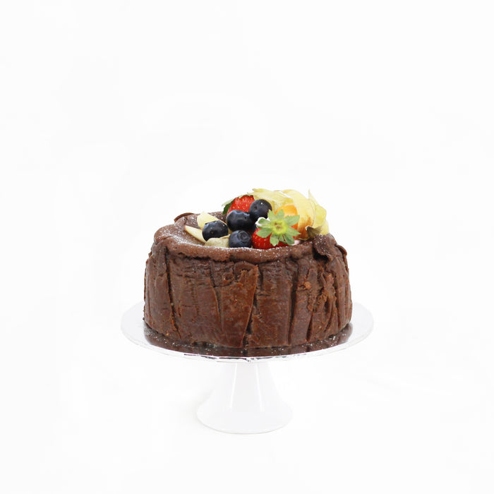 Gluten free dark chocolate burnt cheesecake, topped with fresh fruits