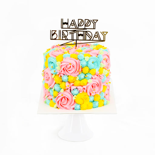 Butter cake decorated with vibrant pink, green and yellow buttercream