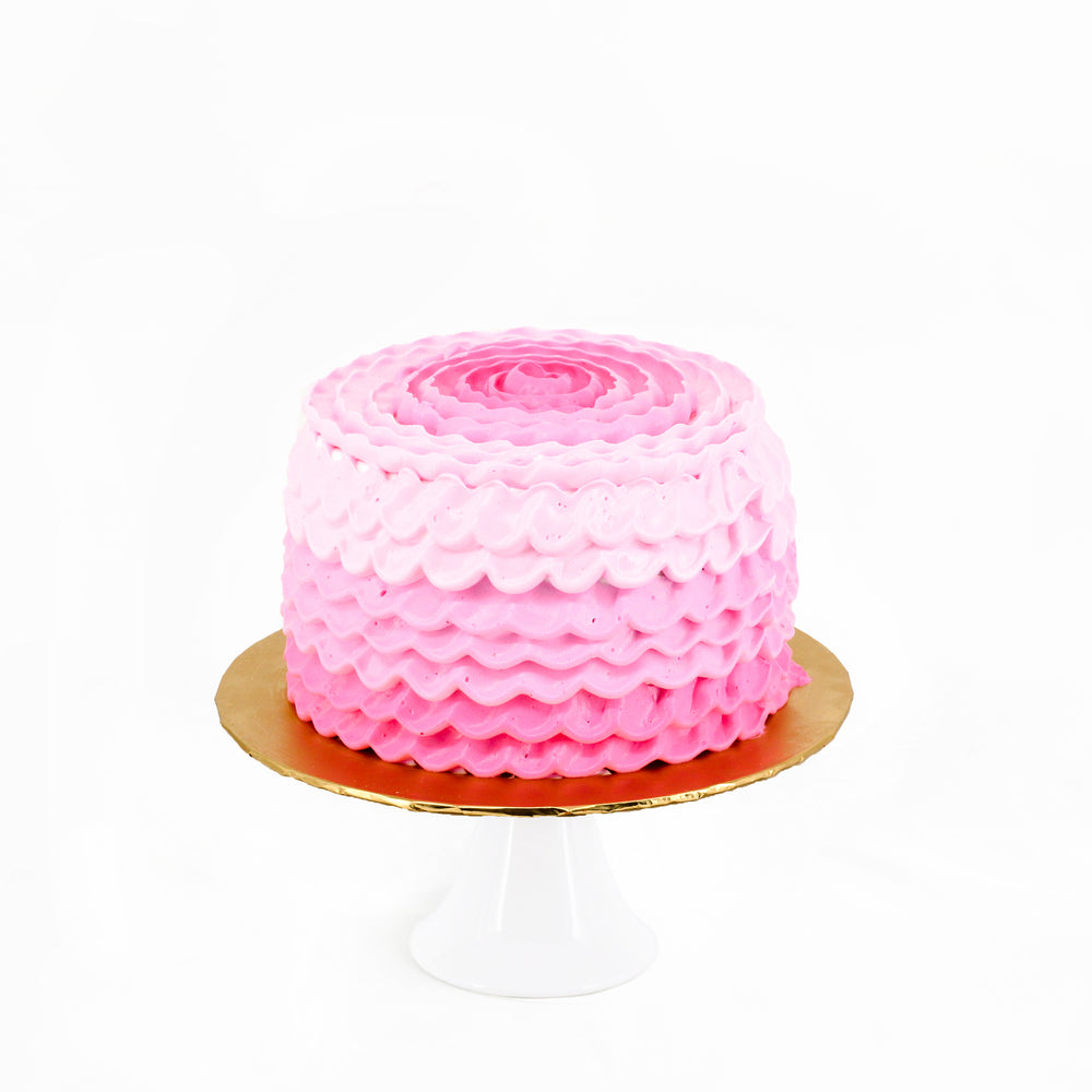 Pink ruffles cake with golden topper