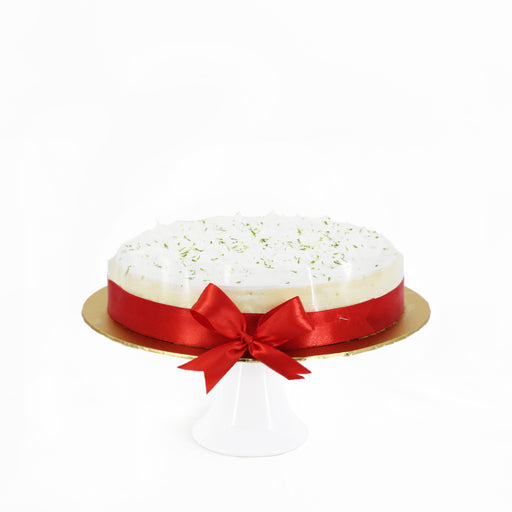 Lime cheesecake tied with a red ribbon