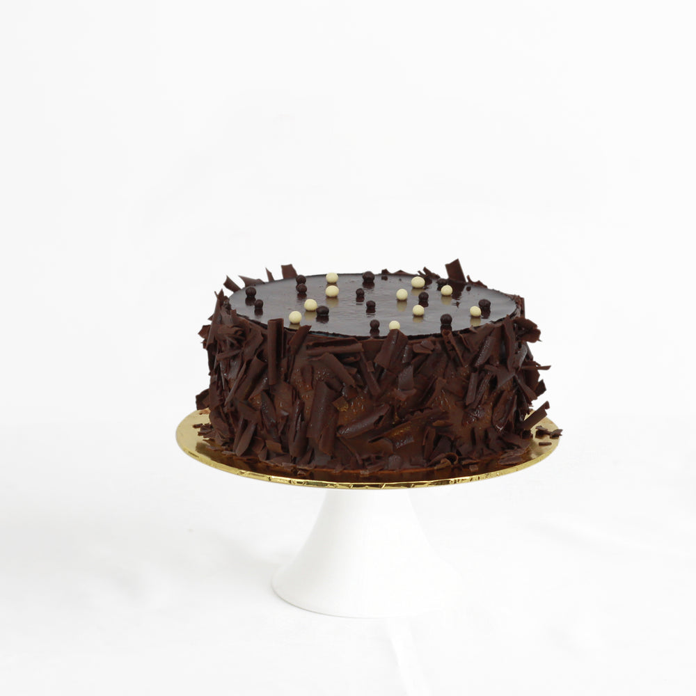 Chocolate mousse and cheese mousse on a chocolate sponge cake, topped with chocolate glaze and shards