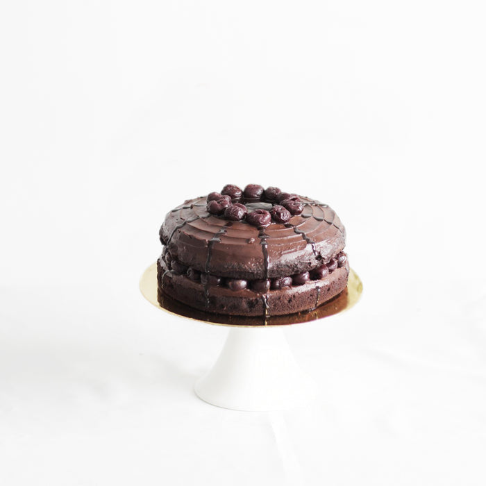 Moist chocolate cake with dark cherries coated in rich chocolate