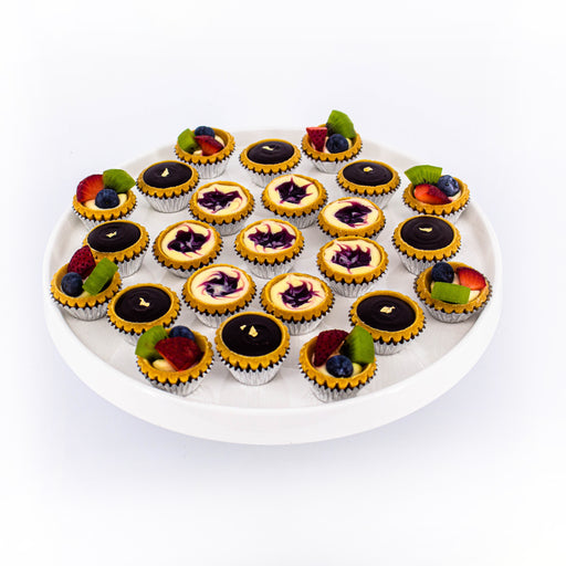 A collection of blueberry cheese tarts, chocolate tarts and fruit tarts