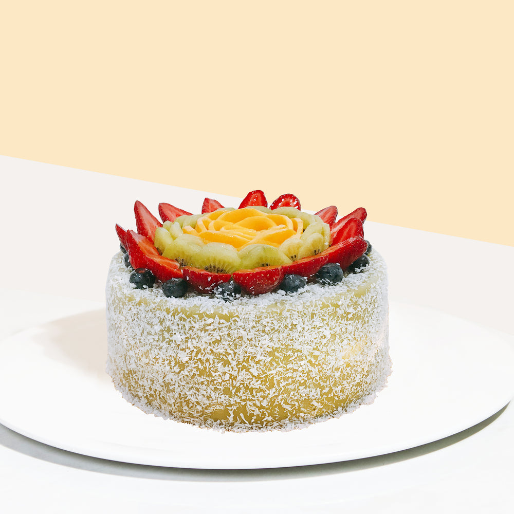 Pandan layer cake with coconut flakes and fresh fruits