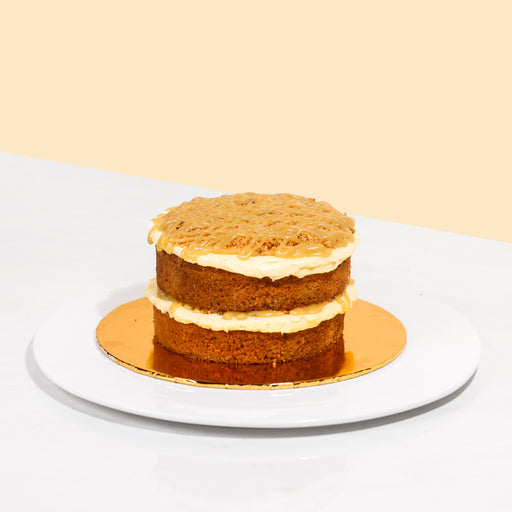 Butter cake layered with butterscotch spread, topped off with cookie crumbs and a generous drizzle of butterscotch sauce.