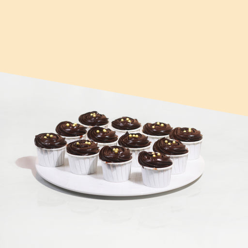 Rich chocolate cupcakes topped with edible gold pearls