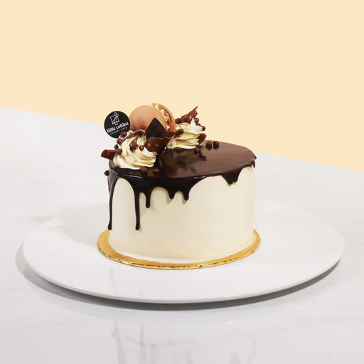Chocolate cake with hazelnut mousse, topped with buttercream and chocolate ganache drip