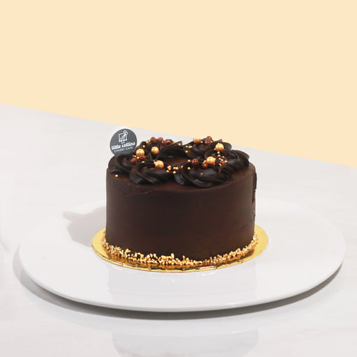 Chocolate cake topped off with edible pearls