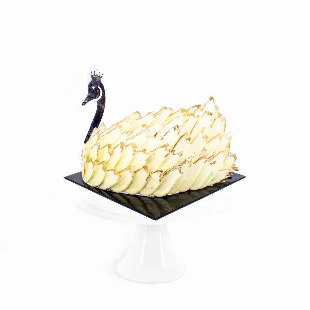 Elegant swan cake with golden tipped white chocolate feathers