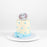 Buttercream cake, decorated with a fondant baby elephant, and fondant blue ribbon