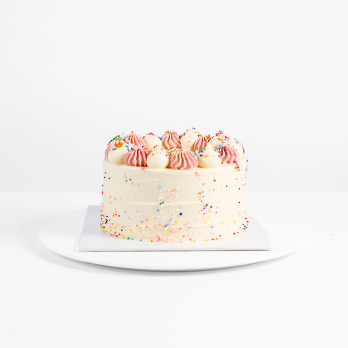 Vanilla cake with sprinkles with berry cream layers