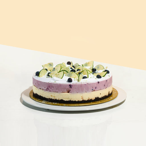 Blueberry cheesecake, with a oreo base, topped off with blueberries and lime slices