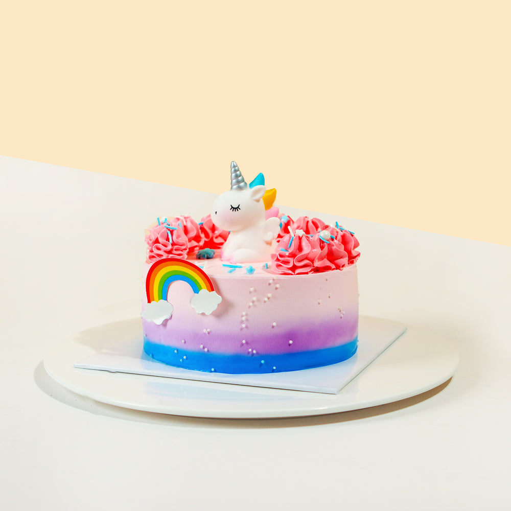 Ombre gradient buttercream cake, with a cute unicorn topper