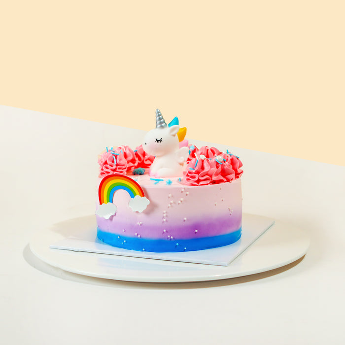 Ombre gradient buttercream cake, with a cute unicorn topper