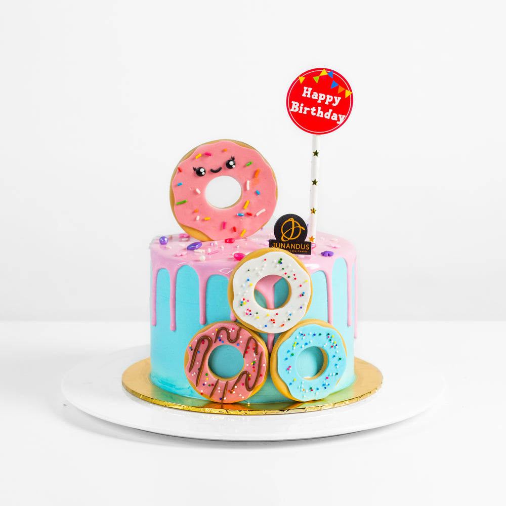 Light blue buttercream cake decorated with donut elements