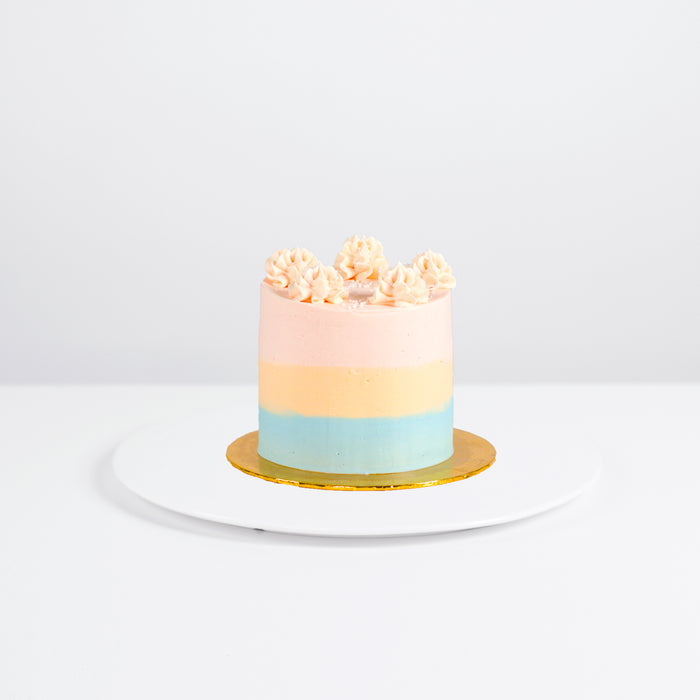 Three toned buttercream cake with vanilla cream cheese and strawberry jam filling