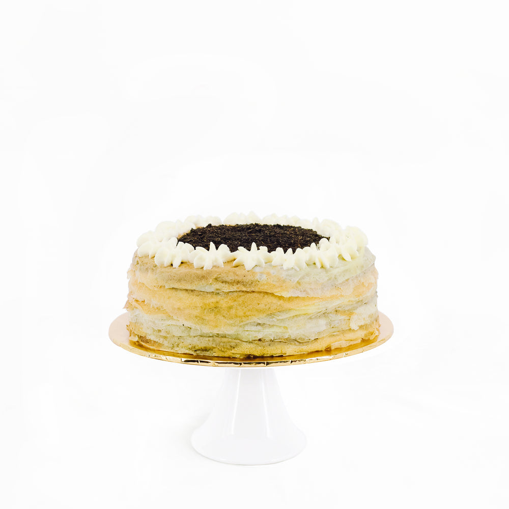 Mille crepe layered with black sesame custard, topped with black sesame powder
