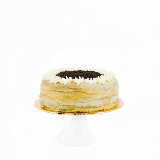 Mille crepe layered with black sesame custard, topped with black sesame powder