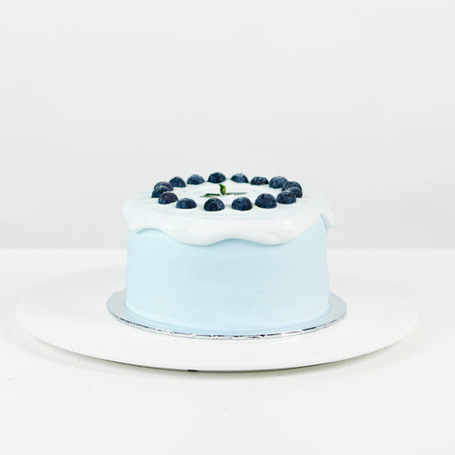 Blueberry chiffon cake topped with cream and blueberries