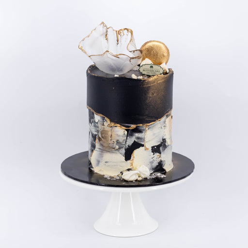 Monochromatic fault-line cake with marble and black buttercream design