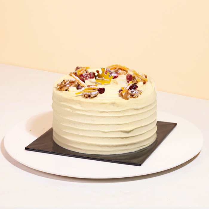 Coconut cake with cream cheese frosting, walnuts, spices and Hawaiian coconut flakes