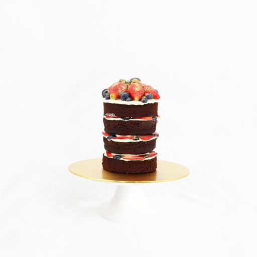 Naked cake filled with fresh cream, blueberries and strawberries