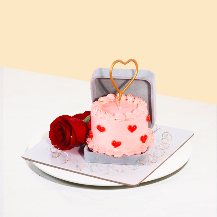 3 inch mini cake within a 'ring holder' with roses on the side