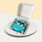 Bento cake with blue buttercream, with hand piped image of a couple