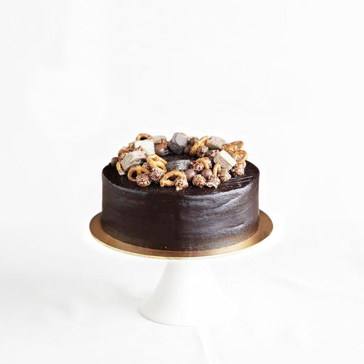Chocolate cake with KitKat bites, chocolate wafers and pretzels